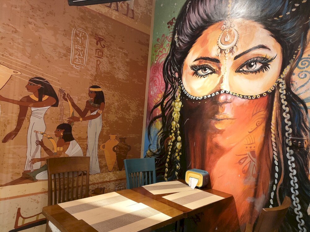 Intricate Egyptian-inspired murals add a unique, artistic touch to your dining experience